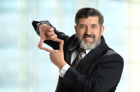 Hispanic Businessman Creating Frame with Hands Foto stock