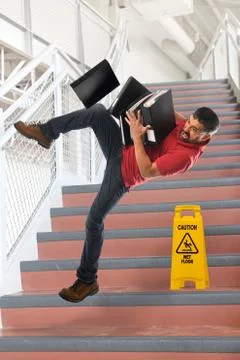 Hispanic Businessman Falling Foto stock