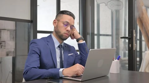 Hispanic Businessman Sleeping while Sitting at Workplace Stock Footage 307917597
