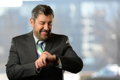 Hispanic Businessman Using Electronic Watch Stock Photos