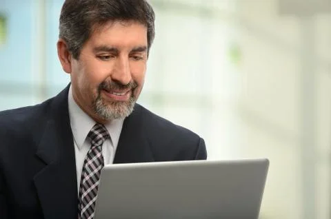 Hispanic businessman using laptop Stock Photos