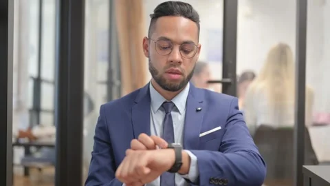 Hispanic Businessman Using Smart Watch at Workspace Video stock 307912530
