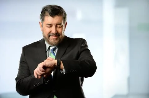 Hispanic Businessman Using Smart Watch Stock Photos