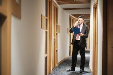 Hispanic Businessman At Work As Manager Talking On Cell Phone Stock Photos