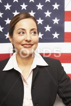 Hispanic businesswoman in front of American flag Stock Photos
