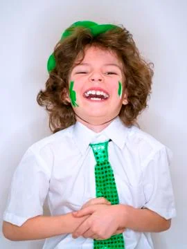 Hispanic child boy having fun during Saint Patrick celebrations over a light  Stock Photos