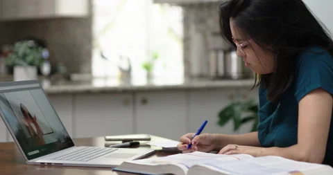 Hispanic College Student Looking for correct page during online learning Video stock 131647346