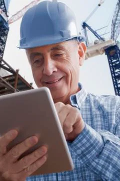 Hispanic construction worker using digital tablet Stock Photos