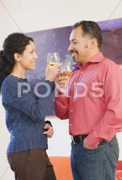 Hispanic Couple Toasting With Wine