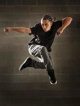 Hispanic dancer leaping in mid air Stock Photos