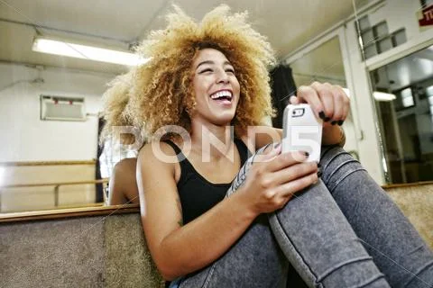 Hispanic Dancer Using Cell Phone In Studio