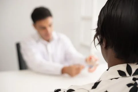 Hispanic dentist explaining to patient about teeth and how to brush with de.. Stock Photos