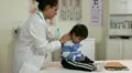 Hispanic doctor checking a small boy HD Footage