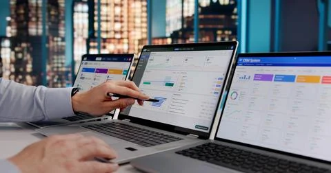Hispanic ERP Expert Evaluating Cloud-Based CRM And Marketing Software On Lapt Stock Photos