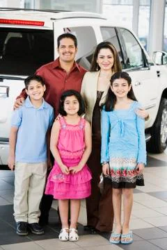 Hispanic family at car dealership Stock Photos