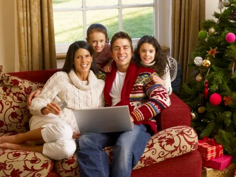 Hispanic family christmas shopping online Stock Photos
