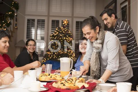 Hispanic Family Enjoying Traditional Christmas Dessert