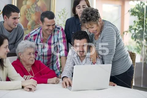 Hispanic family looking at laptop Stock Photos