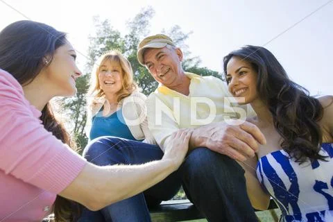 Hispanic Family Relaxing Together Outdoors