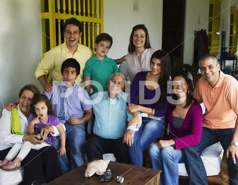 Hispanic family sitting on porch together Stock Photos