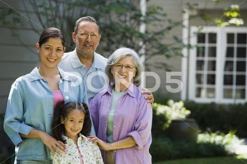 Hispanic family smiling in backyard Stock Photos