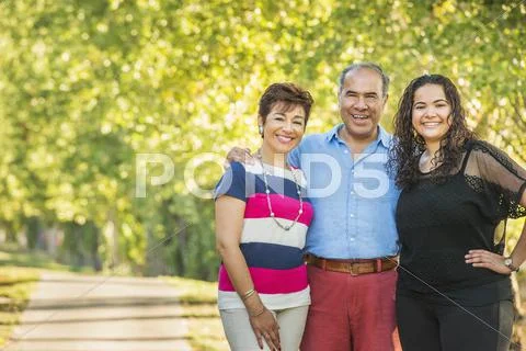 Hispanic Family Smiling Together Outdoors