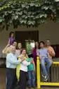 Hispanic family standing on porch together Stock Photos