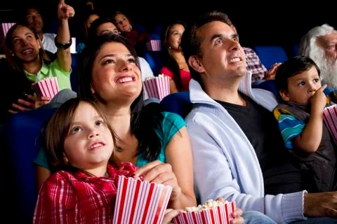 Hispanic family watching film in movie theater Stock Photos