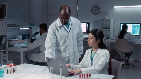 Hispanic Female Bioengineering Researcher Working on Report in Lab Stock Footage 312380919