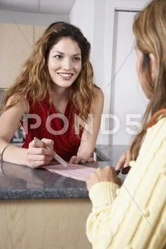 Hispanic female medical professional helping patient Stock Photos