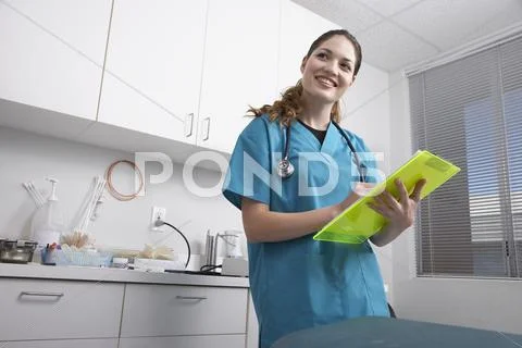 Hispanic female medical professional holding chart Stock Photos