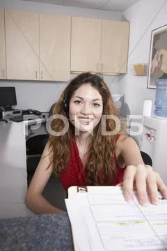 Hispanic female medical professional taking chart Stock Photos