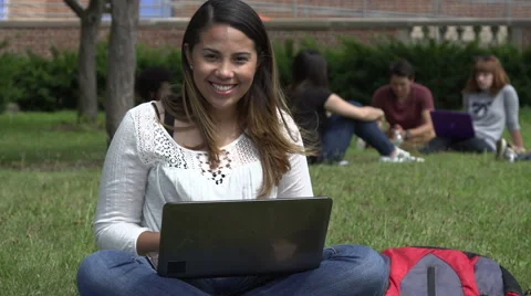 Hispanic female student, typing outside, smiles to camera. Stock Footage 44117200