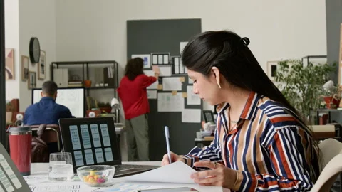 Hispanic Female UI Designer Working on New Mobile Application in Office Stock Footage 327908264