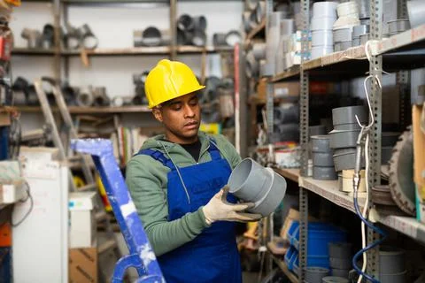 Hispanic foreman looking for construction supplies in building hypermarket Fotos de archivo
