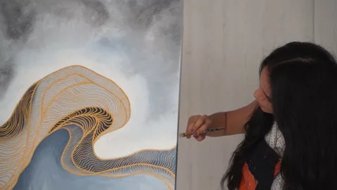 Hispanic Girl Brushing Paint On Side Of Canvas While Talking. - close up Stock Footage 149105802