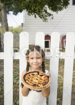Hispanic girl holding homemade pie Stock Photos