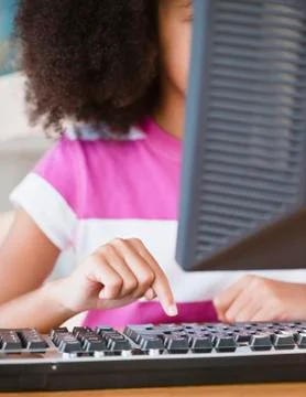 Hispanic girl using computer 스톡 사진