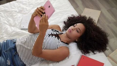 Hispanic Girl Using Digital Tablet For School Homework Video stock 89470689