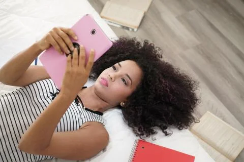 Hispanic Girl Using Digital Tablet For School Homework Stock Photos