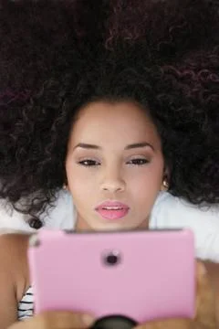 Hispanic Girl Using Digital Tablet For School Homework Stock Photos