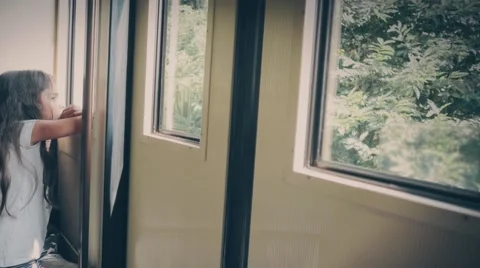 Hispanic girl watching outside window Stock Footage 59651003