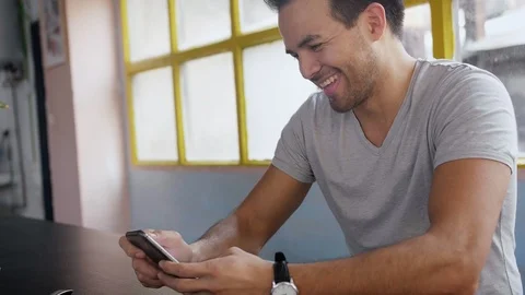 Hispanic handsome guy using new messenger application, scrolls through news feed Stock Footage 105756245