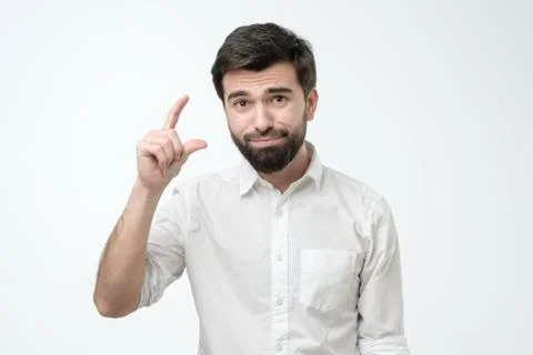 Hispanic handsome pitiful guy showing less gesture salary income savings Stock Photos
