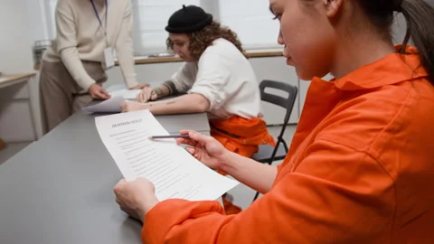 Hispanic Inmate Reading Job Interview Checklist during Life Skills Class Stock Footage 329001085