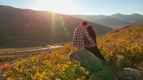 Hispanic-looking couple look at view of the Utah mountains. Stock Footage 99369726