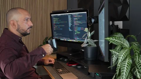 Hispanic Male Programmer IT Engineer Working Drinks Hot Coffee Typing on Stock Footage 281684654