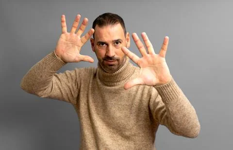 Hispanic man with beard standing over isolated background doing stop gestur.. Stock Photos