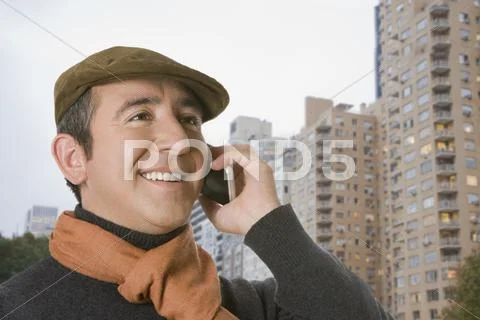 Hispanic Man In Cap Talking On Cell Phone