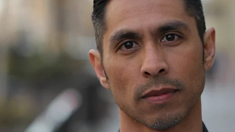 Hispanic man in city face portrait close up angry serious Stock Footage